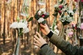 The decorator is working. Wedding flowers decoration arch in the forest. The idea of a wedding flower decoration. Royalty Free Stock Photo