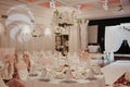Wedding flowers decoration in the restaurant. Banquet round tables, decorated with a bouquet of white flowers in the center of the