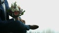 Groom with a bouquet of flowers