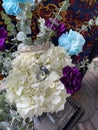 Wedding flowers White Purple Blue flowers in vase with wedding bands