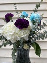 Wedding flowers White Purple Blue flowers in vase with green plants Royalty Free Stock Photo