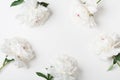 Wedding frame of beautiful white peony flowers on pastel table top view. Flat lay style. Royalty Free Stock Photo