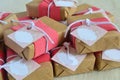 Wedding gifts details beautiful wrapping for guests favors boxes soaps with craft paper and pink fabric decoration