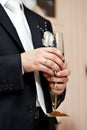 Wedding glass of champagne in hand groom