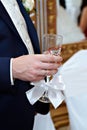 Wedding glass of champagne in hand groom