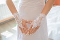 Wedding gloves on the hands of the bride