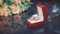 wedding rings on the background of a bouquet of peach roses