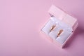 Wedding gold rings in pink gift box on soft pink background Royalty Free Stock Photo