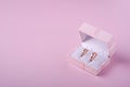 Wedding gold rings in pink gift box on soft pink background Royalty Free Stock Photo