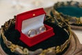 Wedding golden rings bands in a red velvet box in the center of a golden crown. Royalty Free Stock Photo