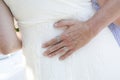 Wedding groom with his hand a the brides back with rings detail Royalty Free Stock Photo