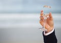 Wedding groom holding champagne celebrating by sea Royalty Free Stock Photo