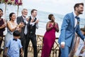 Wedding guests clapping for the bride and groom