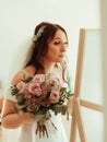 Wedding hairstyle and makeup, beautiful young bride with flowers wreath at marriage morning, happy caucasian girl bridal