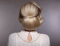 Wedding hairstyle. Portrait of Retro woman with shiny wavy bundle hair, feather in head. Back view of Elegant lady posing isolated Royalty Free Stock Photo