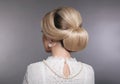 Wedding hairstyle. Portrait of Retro woman with shiny wavy bundle hair, feather in head. Back view of Elegant lady posing isolated Royalty Free Stock Photo