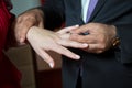 Wedding hands of a bride and groom . Groom put a ring on finger of his lovely wife. Young man putting ring on finger of his Royalty Free Stock Photo