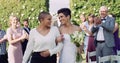 Wedding, happiness and interracial lesbian couple walking down aisle with smile, love and applause. Lgbt marriage