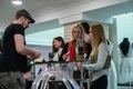 A barman is preparing beverages for visitiors at an exhibition