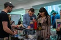 An engaged couple testing beverages from a barman