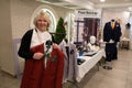A wedding business lady shows a red wedding suit