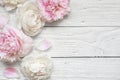 Wedding invitation or anniversary greeting card or Mother`s Day card mockup decorated with pink and creamy peonies Royalty Free Stock Photo
