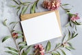 Wedding invitation or greeting card with copy space mockup with envelope and stylish flowers composition