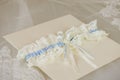 Wedding invitation with a wedding garter Royalty Free Stock Photo