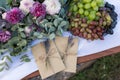 Wedding invitations in the craft envelopes with a few branches of lavender near the flower composition and a tray with grape. Wedd