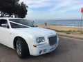 Wedding limousine with sandy beach background