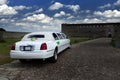 Wedding limousine in the yard of fortress Narva, Estonia - a traditional place of wedding ceremonies of citizens.