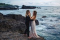 Wedding lovestory, just married couple near the ocean at sunset Royalty Free Stock Photo