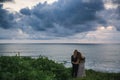 Wedding lovestory, just married couple near the ocean at sunset Royalty Free Stock Photo