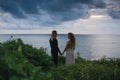 Wedding lovestory, just married couple near the ocean at sunset Royalty Free Stock Photo