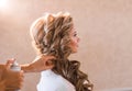 Wedding makeup artist making a make up for bride. Beautiful model girl indoors. Beauty blonde woman with curly hair Royalty Free Stock Photo