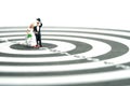 Wedding married target goal conceptual miniature people toy photography. Bride and groom standing above dartboard. Image photo