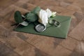 Wedding mock-up with invitation cards in green envelope on wooden background