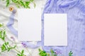 Wedding mockup with violet flowers and delicate silk ribbons on a white background. Greeting card or wedding invitation with Royalty Free Stock Photo