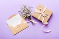 Wedding mockup with white paper list and flowers gypsophila on colored table top view flat lay. Blank greeting cards and Royalty Free Stock Photo