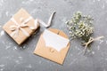 Wedding mockup with white paper list and flowers gypsophila on colored table top view flat lay. Blank greeting cards and Royalty Free Stock Photo