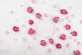 Wedding mockup with white round blank, pink rose flowers and petals on light table top view. Beautiful floral pattern. Flat lay Royalty Free Stock Photo