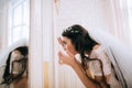 Wedding morning. The bride looks in the mirror Royalty Free Stock Photo