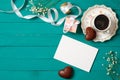 Wedding morning concept. Invitation card, heart-shaped chocolate, gift box, cup of coffee, daisy flowers. Stylish minimal women`s