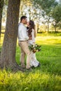 Wedding in the mountains. Beautiful couple of brides kissing standing on a mountain on a background of sunset in the Royalty Free Stock Photo