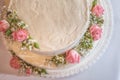 Wedding naked cake decorated with fresh flowers on top, product photography for patisserie Royalty Free Stock Photo