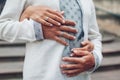 Wedding newlyweds couple wearing rings on fingers. Bride and groom wear traditional embroidered ukrainian shirts