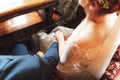 Wedding pair sitting on chairs during wedding ceremony. Close up of clasped man and woman hands. Loving couple. Wedding Royalty Free Stock Photo