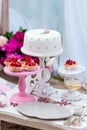 Wedding or party candy bar, decorated dessert table in pink color with cakes. Shabby chic style Royalty Free Stock Photo