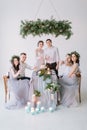 Wedding party at dinner - Bridal couple with bridesmaids and groommen drinking champagne and have fun at the decorated Royalty Free Stock Photo