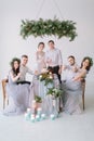 Wedding party at dinner - Bridal couple with bridesmaids and groommen drinking champagne and have fun at the decorated Royalty Free Stock Photo